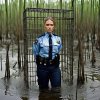 a caged policewoman in a swamp.jpg