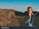 stock-photo-hot-girl-in-autumn-field-young-woman-wearing-jeans-covering-chest-with-check-shirt...jpg