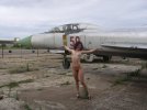 Naked-curly-girl-walking-in-the-aircraft-museum-27.jpg