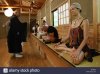 niiza-japan-foreign-tourists-practicing-zazen-with-a-monk-BXY48E.jpg