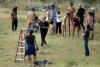 People-prepare-to-pose-nude-as-photographer-Spencer-Tunick-looks-to-the-sky-during-his-art-ins...jpg