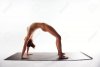 28268809-beautiful-young-naked-woman-arching-her-back-on-yoga-mat-over-white-background-nude-w...jpg