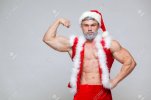 88300104-christmas-sexy-santa-claus-young-muscular-man-wearing-santa-claus-hat-demonstrate-his...jpg
